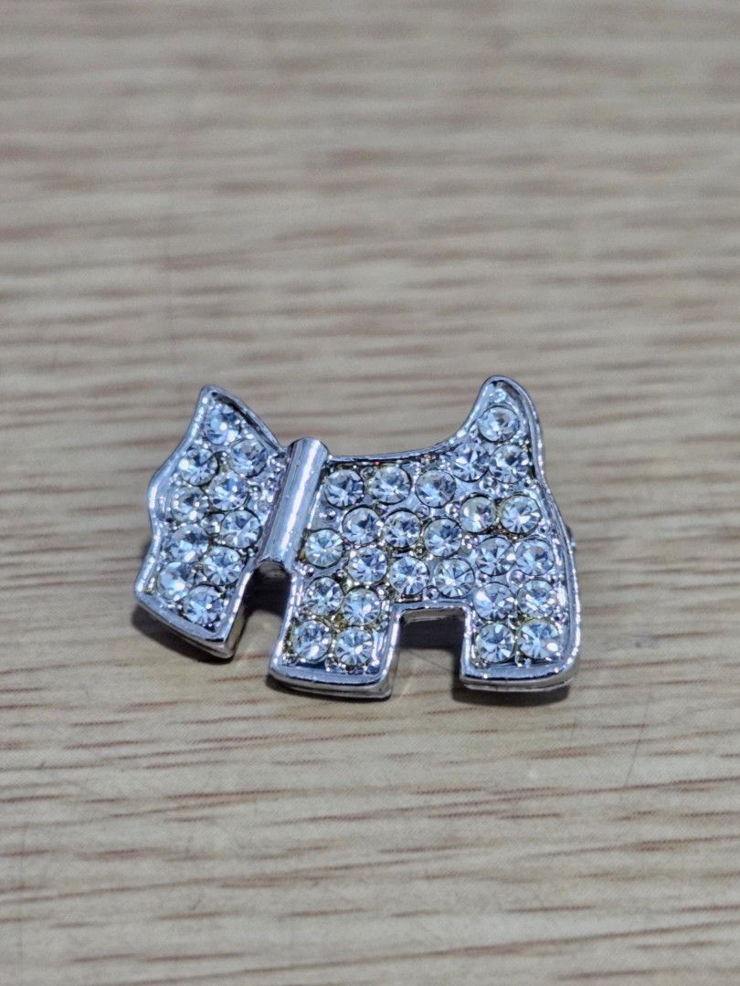 Scotty Dog Rhinestone Silver Brooch Pin (Category: Brooches) located in Caloocan City. Submitted by smart_shoppers_ville (Listing ID 1469168046, Image 2). Description: - Design: Silver tone Scottish terrier dog shape - Sparkle: Fully covered in small clear rhinestones with a matching collar - Backing: Solid metal with a textured finish and standard pin back closure - Styling: Perfect cute accessory for jackets, bags, or scarves.