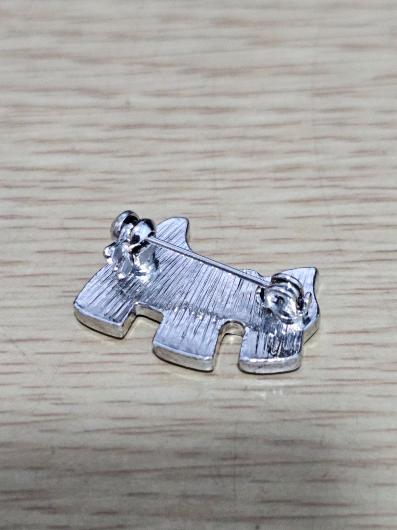 Scotty Dog Rhinestone Silver Brooch Pin (Category: Brooches) located in Caloocan City. Submitted by smart_shoppers_ville (Listing ID 1469168046, Image 3). Description: - Design: Silver tone Scottish terrier dog shape - Sparkle: Fully covered in small clear rhinestones with a matching collar - Backing: Solid metal with a textured finish and standard pin back closure - Styling: Perfect cute accessory for jackets, bags, or scarves.