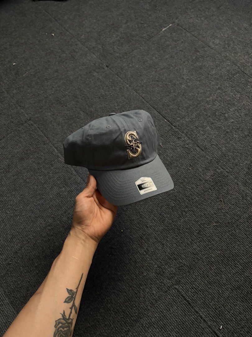 Seattle Mariners MLB Adjustable Cap Grey (Category: Caps & Hats) located in Manila. Submitted by toys_hats005 (Listing ID 1469183726, Image 1). Description: - Brand: Seattle Mariners - Color: Dark Grey - Condition: Brand new with original store tags - Fit: Classic dad hat with curved brim - Details: Embroidered gold and white team logo on the front - Closure: Adjustable strap with metal hardware.