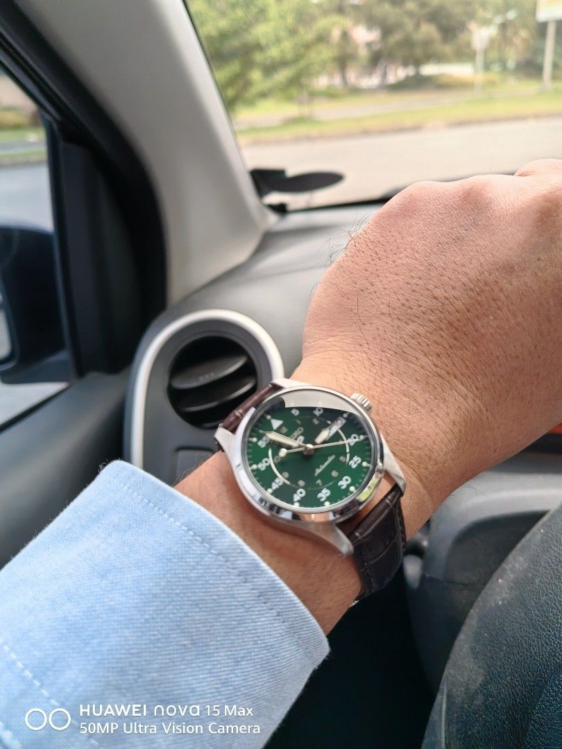 Seiko 5 Automatic Green Dial Watch (Category: Men's Watches) located in Bacoor. Submitted by happydolphin.239038 (Listing ID 1469178275, Image 3). Description: - Brand/Model: Seiko 5 Automatic Watch - Dial: Deep green with field-style outer minute track and inner 12-hour markings - Features: Silver-tone hands, day-date window at 3 o'clock, and exhibition caseback showing the automatic movement - Case: Polished stainless steel - Strap: Dark brown 