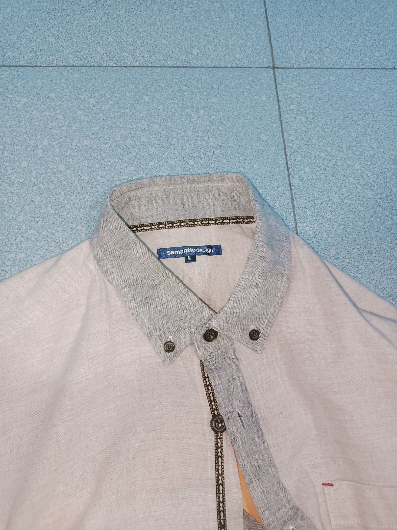 Semantic Design Beige Grey Casual Button Down Shirt Size L (Category: Tshirts & Polo Shirts ) located in Magalang. Submitted by secondhand_thrift (Listing ID 1469177781, Image 2). Description: - Brand: Semantic Design - Size: L - Color: Cream/light beige body with grey contrast collar, cuffs, and placket - Details: Left chest pocket, button-up closure with decorative inner trim - Material: Lightweight fabric - Condition: Great for casual wear.