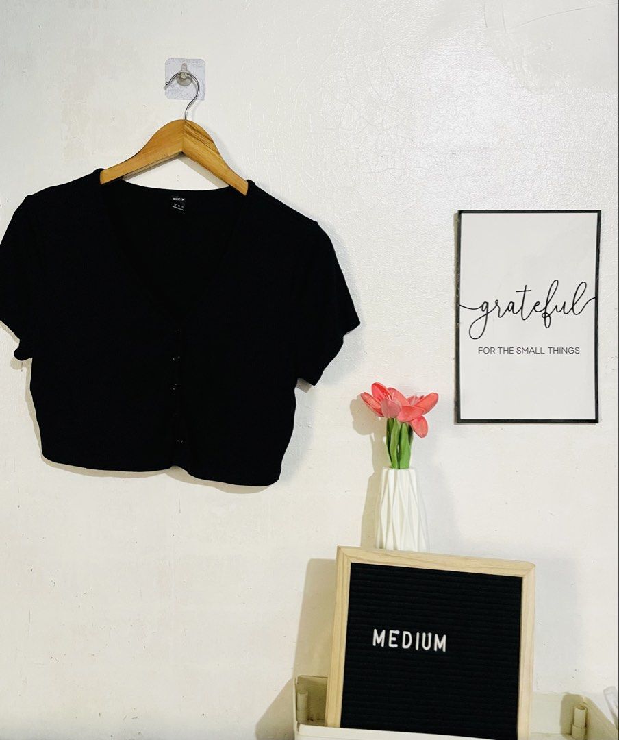 Shein Black Ribbed Button-Up Crop Top (Category: Sleeveless) located in Caloocan City. Submitted by lovemyclothes21 (Listing ID 1469273476, Image 1). Description: - Brand: Shein - Style: V-neck ribbed crop top with short sleeves - Details: Functional button-down front with matching black buttons - Material: Stretchy knit fabric - Fit: Cropped length, hits around the waist - Condition: Clean, well-kept, and great for layering.