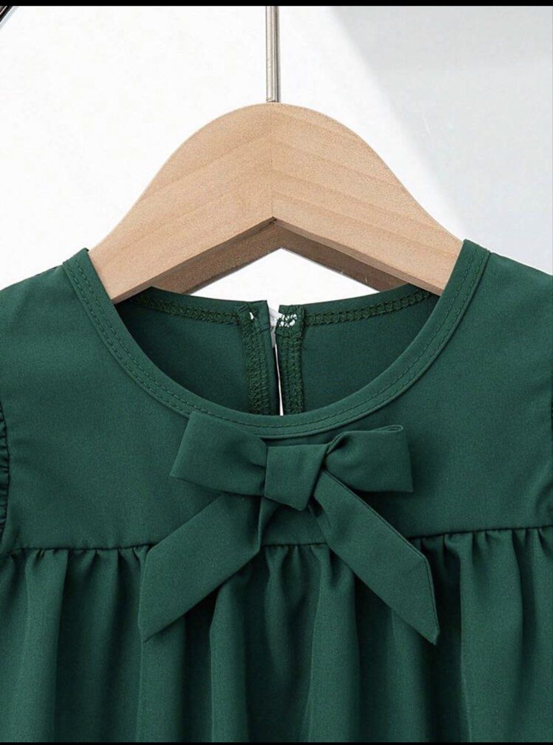 Shein Dark green dress (Category: Babies & Kids Fashion) located in Manila. Submitted by monstershaaa (Listing ID 1469164517, Image 3). Description: used once only - wedding event 18-24 months no damage - no issue rfs : small na kay baby girl - Size: 18-24 months - Color: Dark green - Design: Cap sleeves with ruffles, sweet front bowknot - Details: Scalloped hem with delicate cut-out burn-out embroidery - Closure: Convenient button closure at the