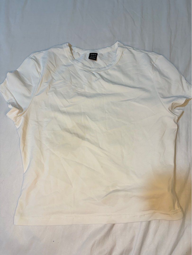 SHEIN White Basic Crew Neck T-Shirt Size M (Category: Shirts) located in Manila. Submitted by thriftwithgem (Listing ID 1469255236, Image 1). Description: - Brand: SHEIN - Color: White - Size: Medium (Regular Fit) - Material: Soft cotton blend - Design: Classic crew neck, short sleeves - Condition: Good, but needs ironing due to storage wrinkles - Style: Versatile daily casual wear, easy to match with jeans or skirts.