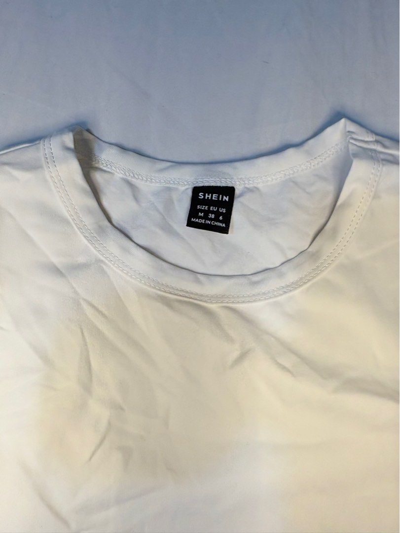 SHEIN White Basic Crew Neck T-Shirt Size M (Category: Shirts) located in Manila. Submitted by thriftwithgem (Listing ID 1469255236, Image 2). Description: - Brand: SHEIN - Color: White - Size: Medium (Regular Fit) - Material: Soft cotton blend - Design: Classic crew neck, short sleeves - Condition: Good, but needs ironing due to storage wrinkles - Style: Versatile daily casual wear, easy to match with jeans or skirts.