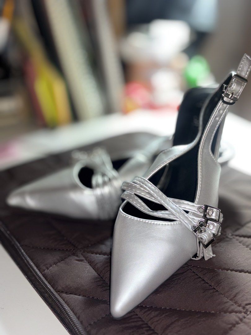 Silver Pointed Toe Slingback Heels with Buckle Straps (Category: Heels) located in Bulacan. Submitted by ace_g (Listing ID 1469232183, Image 2). Description: - Color: Silver metallic with black interior lining - Design: Pointed toe with slingback strap and adjustable metal buckle - Details: Multiple decorative front buckle straps - Style: Chic and modern - Occasion: Ideal for weddings, dinners, parties, and evening events.