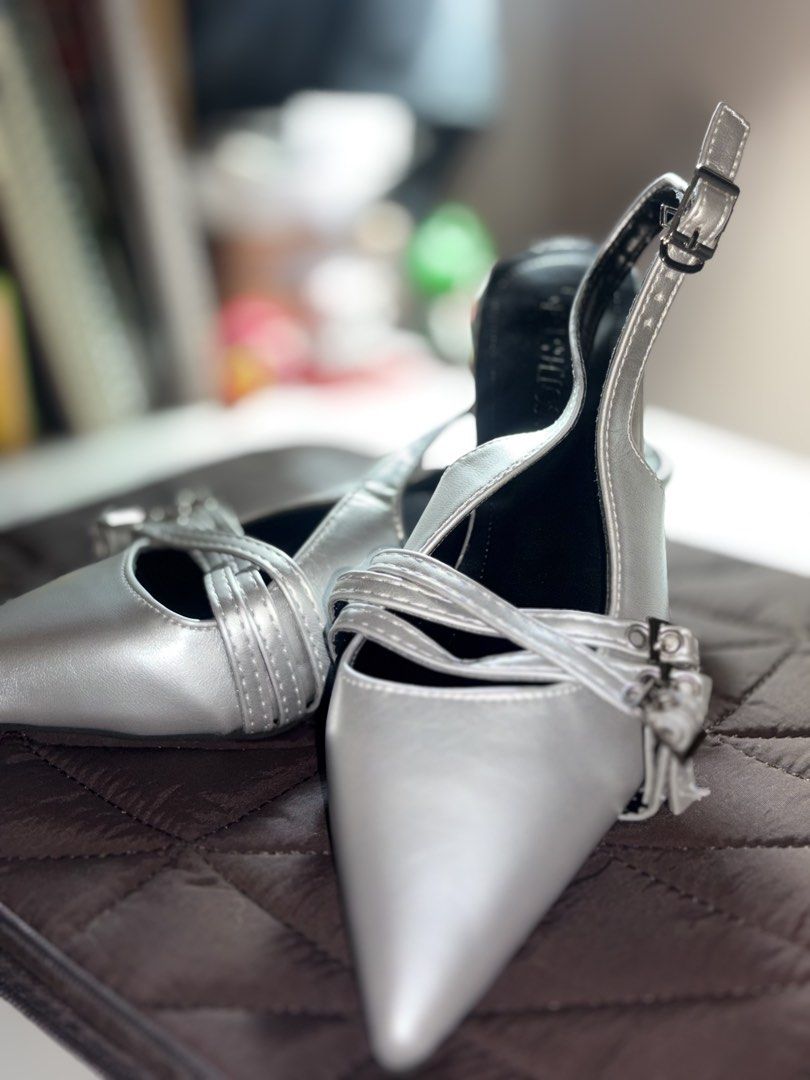 Silver Pointed Toe Slingback Heels with Buckle Straps (Category: Heels) located in Bulacan. Submitted by ace_g (Listing ID 1469232183, Image 1). Description: - Color: Silver metallic with black interior lining - Design: Pointed toe with slingback strap and adjustable metal buckle - Details: Multiple decorative front buckle straps - Style: Chic and modern - Occasion: Ideal for weddings, dinners, parties, and evening events.
