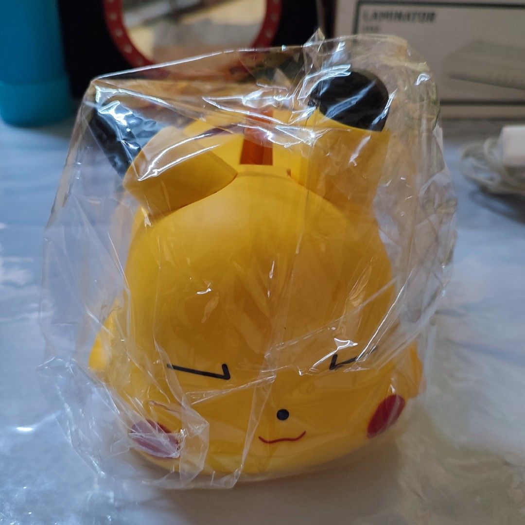 Sleeping Pikachu Tissue Holder Yellow (Category: Designer & Blind Box Toys) located in Manila. Submitted by shop_eyy (Listing ID 1469169472, Image 2). Description: - Design: Adorable sleeping Pikachu face with signature red cheeks and black ear tips - Function: Tissue holder - Condition: Clean surface .