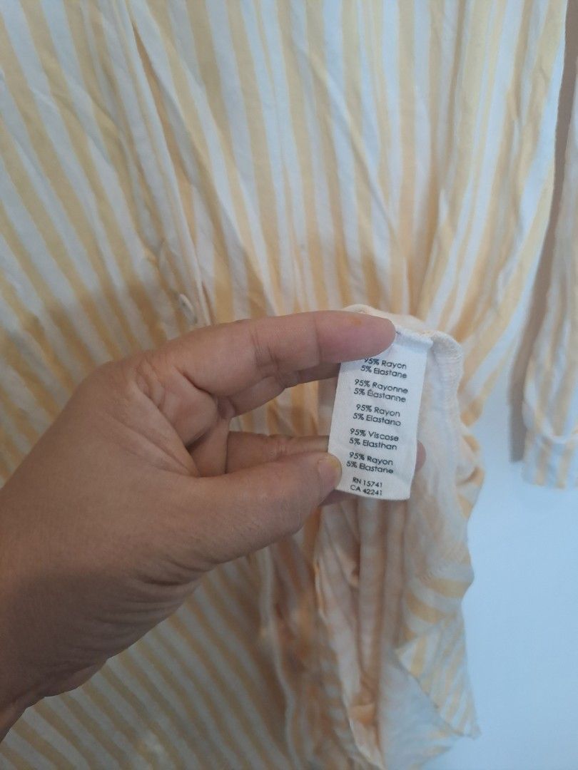 Sleepwear rayon yellow stripes (Category: Dresses) located in Manila. Submitted by joanbalde39643 (Listing ID 1469230406, Image 3). Description: The item in the image is a women's yellow and white vertical striped nightshirt featuring a button-down front, long sleeves, a notch collar, and a single chest patch pocket. It is designed as an oversized, relaxed lounge dress or a sleepwear top..