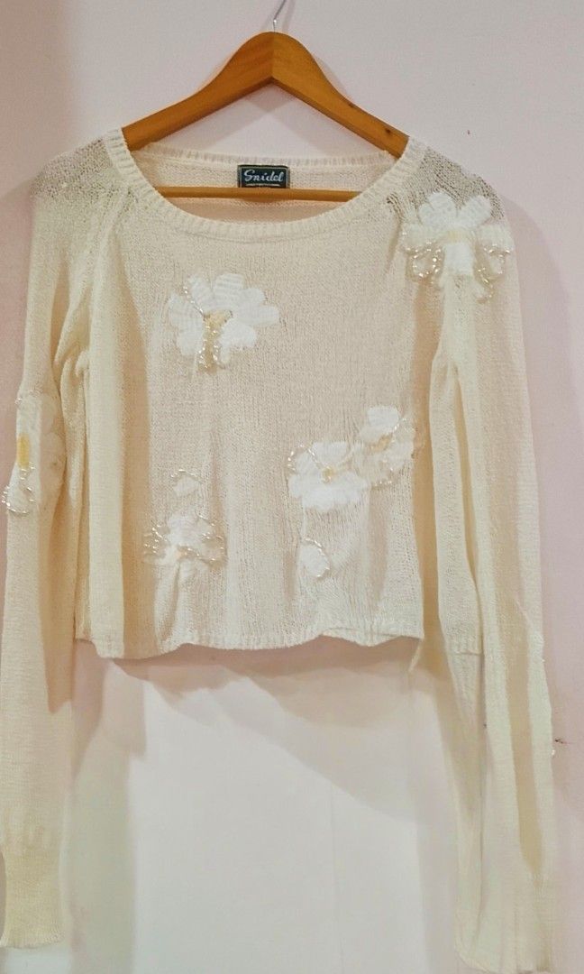 SNIDEL cropped white knit sweater (Category: Blouses) located in Cabanatuan. Submitted by miss.maia (Listing ID 1469307130, Image 3). Description: Archived SNIDEL cropped white knit sweater adorned with sheer floral organza appliqués and delicate bead/sequin embellishments . Freesize.
