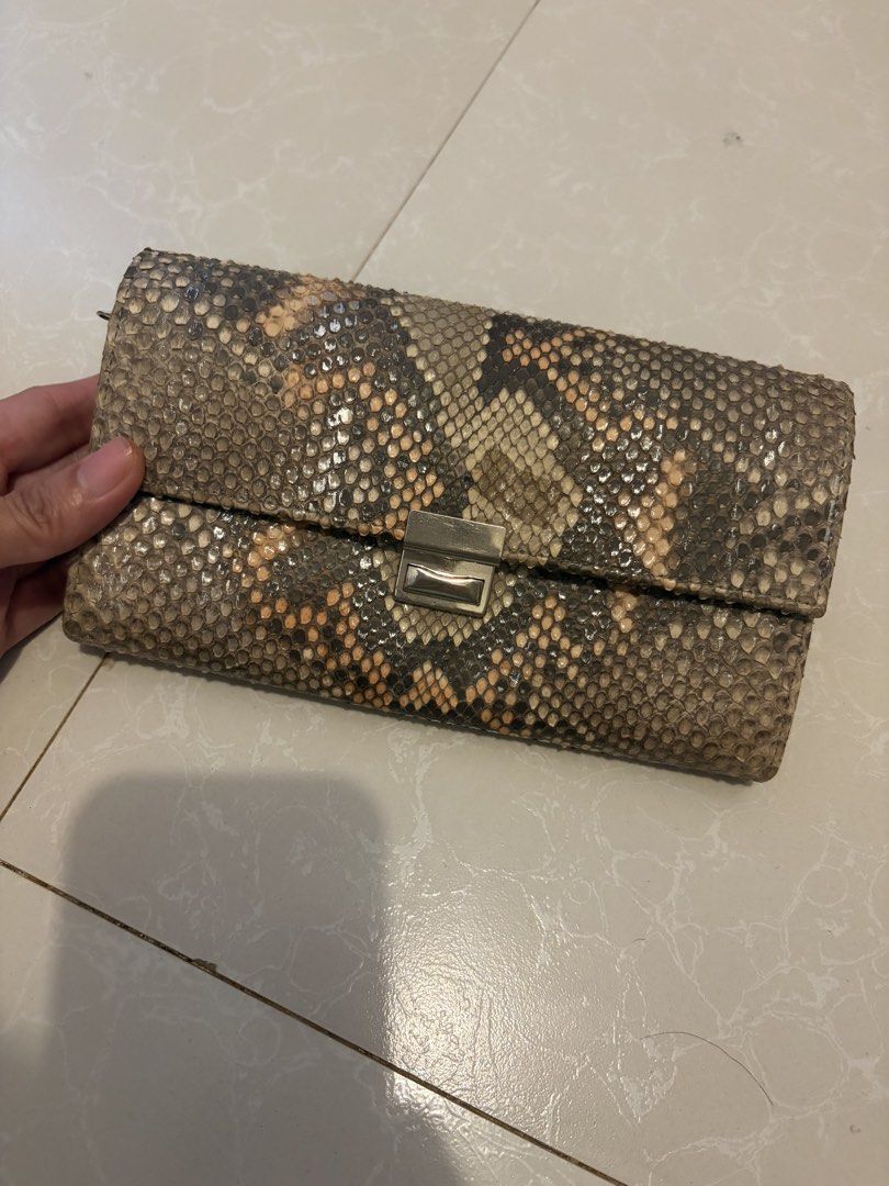 ísola Japan Genuine Snakeskin Python Long Wallet (Category: Wallets & Card holders) located in Las Pinas. Submitted by bibliomomma (Listing ID 1469239417, Image 1). Description: Authentic Japanese Ísola ottanta-sette long wallet featuring a genuine python/snakeskin exterior paired with a mustard yellow leather interior. Designed with a silver push lock clasp, multiple accordion compartments, card slots, and a rear zippered pocket for maximum orga