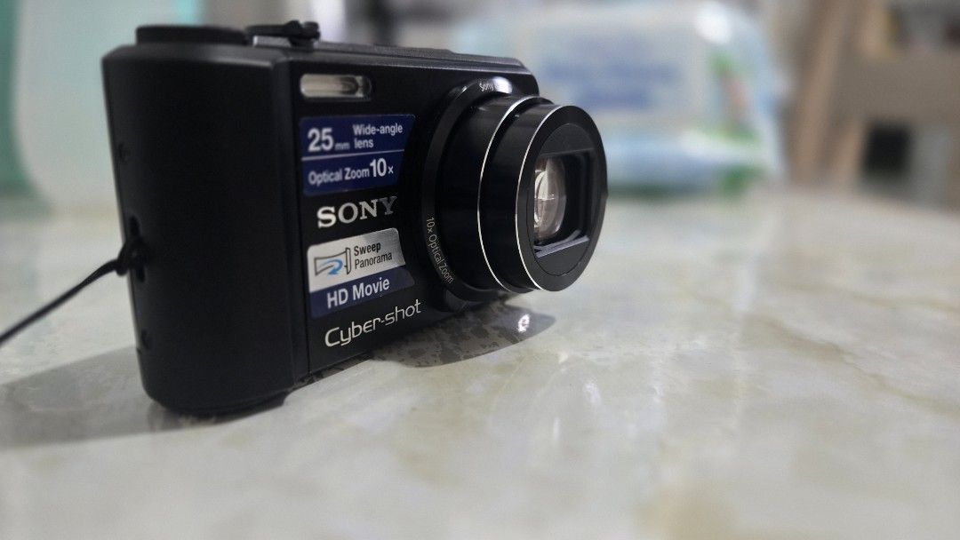 Sony Cyber-shot DSC-H70 Digital Camera (Category: Cameras) located in Paranaque City. Submitted by maracasas (Listing ID 1469204388, Image 2). Description: - Model: Sony Cyber-shot DSC-H70 (Black) - Resolution: 16.1 Megapixels - Zoom: 10x Optical Zoom with 25mm Wide-Angle - Video: HD Movie Recording Capability - Features: Sweep Panorama Mode and bright LCD screen - Condition: Good working condition, ready to use.