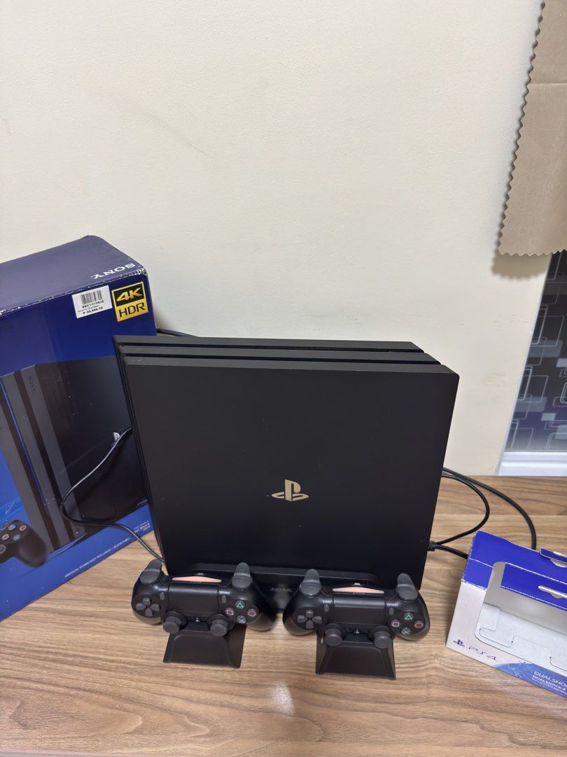 Sony PlayStation 4 Pro 1TB Console with 2 Controllers and UFC 3 (Category: PlayStation) located in Manila. Submitted by seayouncey (Listing ID 1469289278, Image 2). Description: - Console: Sony PlayStation 4 Pro 1TB in Jet Black (fully working, original box included) - Controllers: 2 x Original DualShock 4 wireless controllers - Accessories: Dual controller charging docks included - Game: UFC 3 physical game disc - Condition: Excellent setup, rea