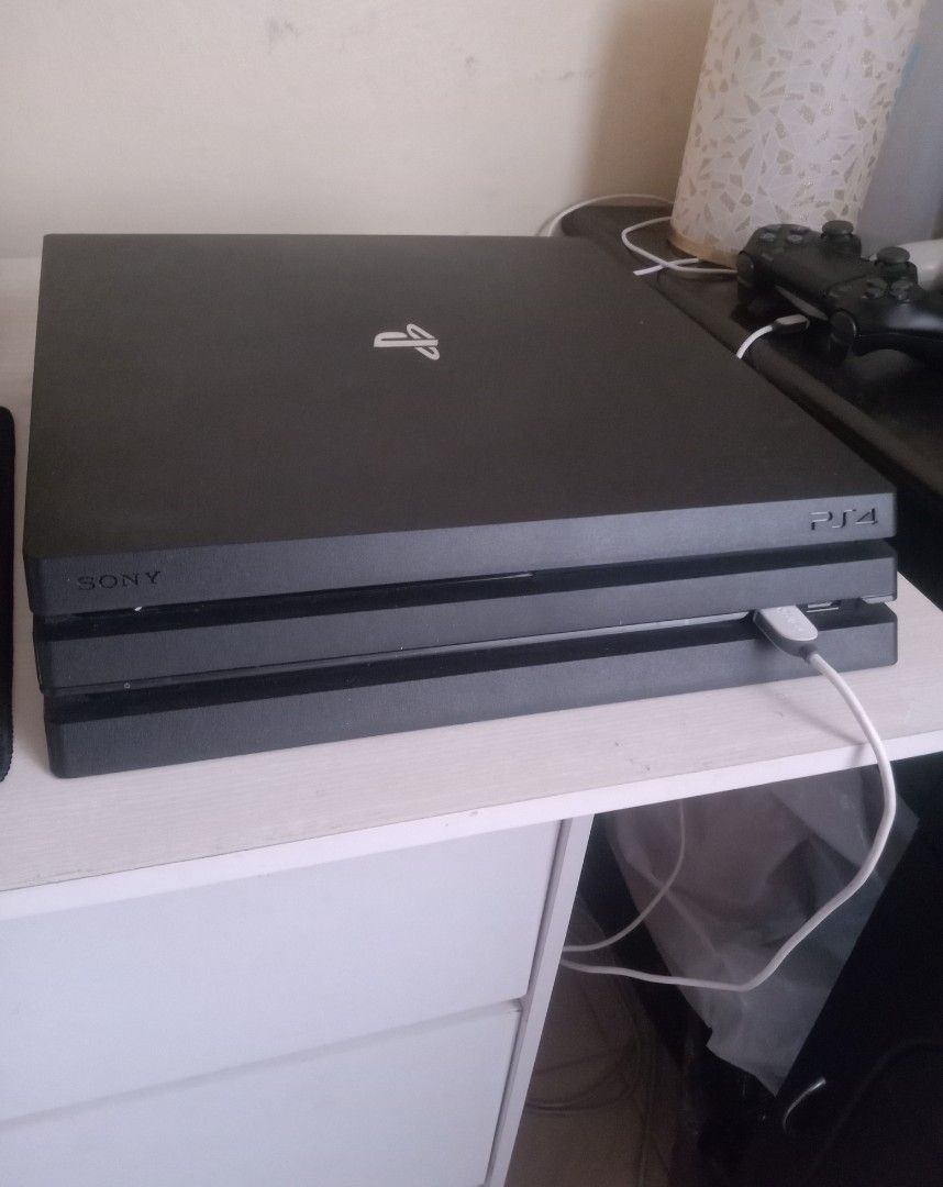 Sony PlayStation 4 Pro Console (Category: PlayStation) located in Manila. Submitted by epicdog_7c7e01 (Listing ID 1469163667, Image 1). Description: - Model: Sony PlayStation 4 Pro (Matte Black) - Condition: Powers up normally, clean exterior with minor dust near vents - Includes: 1x Controller and charging cable - Design: Standard slim three-tier design with classic branding - Status: Tested and 100% working.