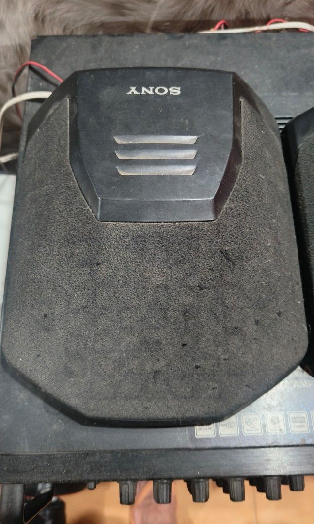 Sony SS-SR991 mini surround speakers (Category: Soundbars, Speakers & Amplifiers) located in Batangas. Submitted by riyanasiafashionshop (Listing ID 1469330078, Image 3). Description: Key Details & Condition Design: These compact, pentagonal-shaped speaker enclosures are wrapped in black fabric mesh grills. They feature distinct silver accents at the top embossed with the SONY logo and three horizontal vent-style decorative lines. Application: Th