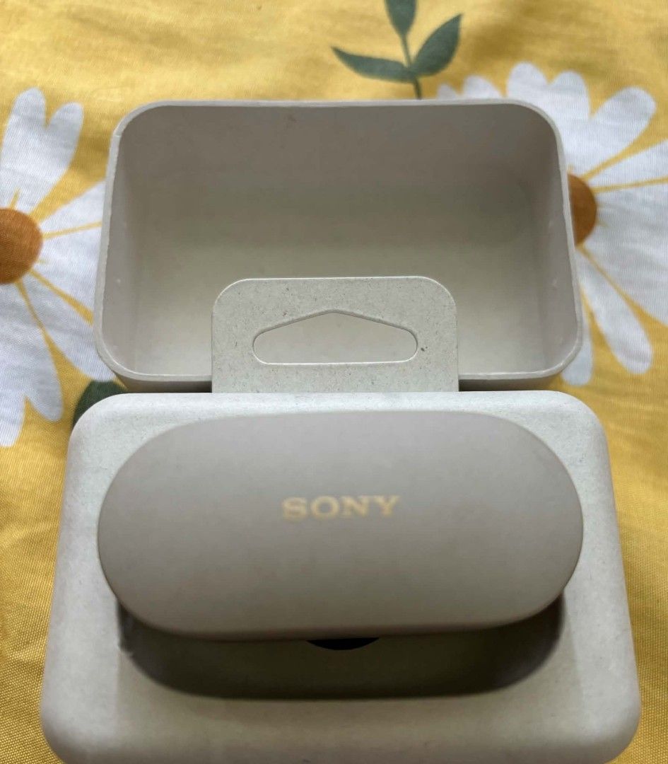 Sony WF-1000XM4 Wireless Earbuds (Category: Headphones & Headsets) located in Bayombong. Submitted by rnstrifty (Listing ID 1469177214, Image 3). Description: Sony WF-1000XM4 wireless noise canceling earbuds in silver/beige colorway. Includes charging case and original paper pulp packaging box. Earbuds sit securely inside the molded case. Battery status indicator lights up green on the front. Fully functional charging case and earphones..