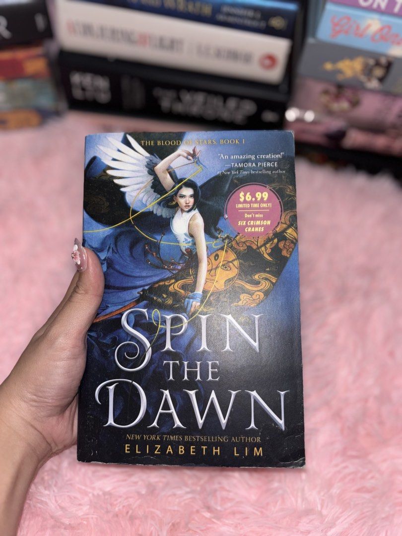 Spin the Dawn by Elizabeth Lim (Category: Storybooks) located in Batangas. Submitted by solunarareads (Listing ID 1469202517, Image 1). Description: - Title: Spin the Dawn (Blood of Stars Series, Book One) - Format: Paperback - Condition: Light shelf wear with minor creasing along the edges and spine; pages and outer edges are clean and intact - Genre: Young Adult (YA) Fantasy - Perfect for readers looking to dive into an immersive new fantasy wo
