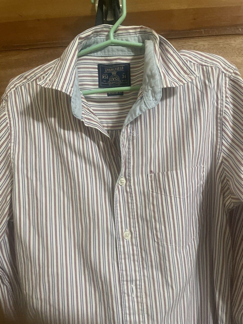 Springfield Striped Long Sleeve Button-Up Shirt XS (Category: Formal Shirts) located in Dumaguete. Submitted by han_heuinanta (Listing ID 1469246199, Image 1). Description: - Brand: Springfield - Fit: Regular fit - Design: White base with red and blue vertical stripes - Size: XS (Collar size 34) - Details: Single chest pocket on the left, white front buttons, and stylish light blue inner collar contrast - Condition: Excellent, ready to wear.