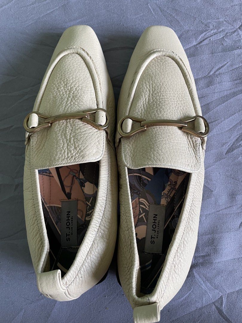 St. John Blue Label Beige Loafers Size 230 (Category: Loafers) located in Cagayan de Oro. Submitted by jekdels05 (Listing ID 1469164047, Image 2). Description: - Brand: St. John Blue Label - Material: Off-white textured leather with fun patterned fabric lining - Details: Gold-tone hardware on front strap, slip-on design - Heel & Sole: Structured square heel with patterned rubber grip soles - Size: 230 stamped on bottom.
