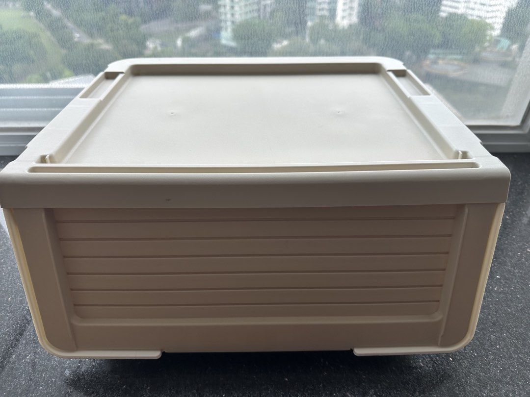 Stackable storage box (Category: Storage Boxes & Baskets) located in Singapore. Submitted by eug7007y (Listing ID 1469248511, Image 1). Description: - Color: Beige - Material: Sturdy plastic - Design: Ribbed front panel drawer door - Features: Flat top lid for stacking - Ideal for: Organizing clothes, toys, and desk supplies.