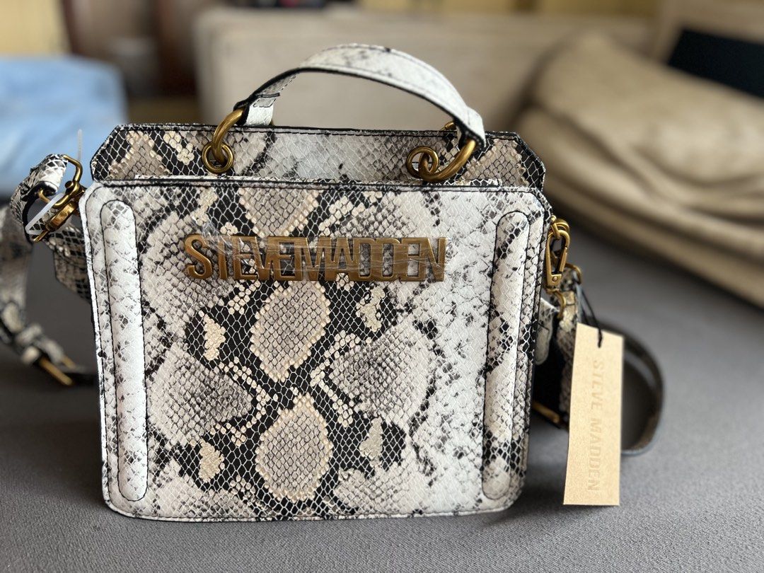 Steve Madden Bevelyn Snake Satchel (Category: Cross-body Bags) located in La Trinidad. Submitted by beryllacambra (Listing ID 1469252912, Image 1). Description: - Brand: Steve Madden - Style: Bevelyn Snake Satchel - Color/Pattern: Metallic snake print - Design: Structured box shape with top handle - Extras: Includes detachable branded black strap and matching mini pouch - Condition: Brand new with original tag attached (MSRP $88.00) - Details: Fr