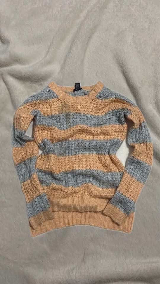 Striped Knit Sweater Peach and Grey (Category: Longsleeves) located in Manila. Submitted by nobleowl-8fff (Listing ID 1469290205, Image 1). Description: - Style: Peach and grey striped sweater - Design: Wide open-knit texture with a classic crew neckline and long sleeves - Fit: Easy, relaxed fit for everyday wear - Material: Soft and breathable knit - Pairing: Perfect to match with denim or casual pants.
