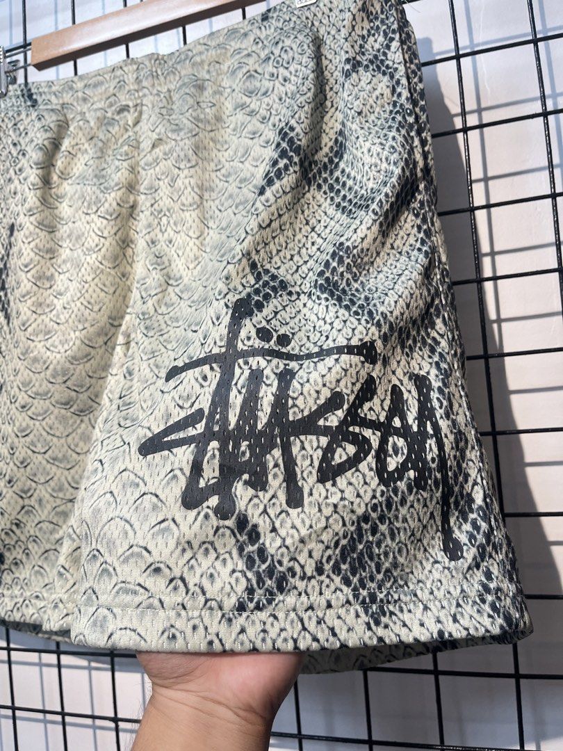 Stüssy Snake Mesh Shorts (Category: Shorts) located in Taal. Submitted by thrift_deals23 (Listing ID 1469183831, Image 2). Description: - Brand: Stüssy - Item: Allover Snakeskin Print Mesh Shorts - Size: XL - Color/Print: Snakeskin with black graffiti logo on left leg - Features: Elastic waistband, white inner drawstring, inner mesh lining - Condition: Brand new with tags attached - Origin: Made in Vietnam - Style Number: 1140340.