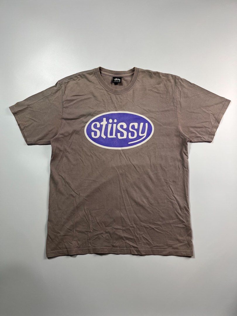 Stussy Oval Logo Tee Brown (Category: Tshirts & Polo Shirts ) located in Iloilo. Submitted by lowesdrift (Listing ID 1469208093, Image 1). Description: - Brand: Stussy - Color: Brown with a washed-out vintage tone - Size: L (Made in Honduras) - Design: Large oval logo printed on the back - Fit/Style: Crew neck with short sleeves - Material: Comfortable cotton fabric.