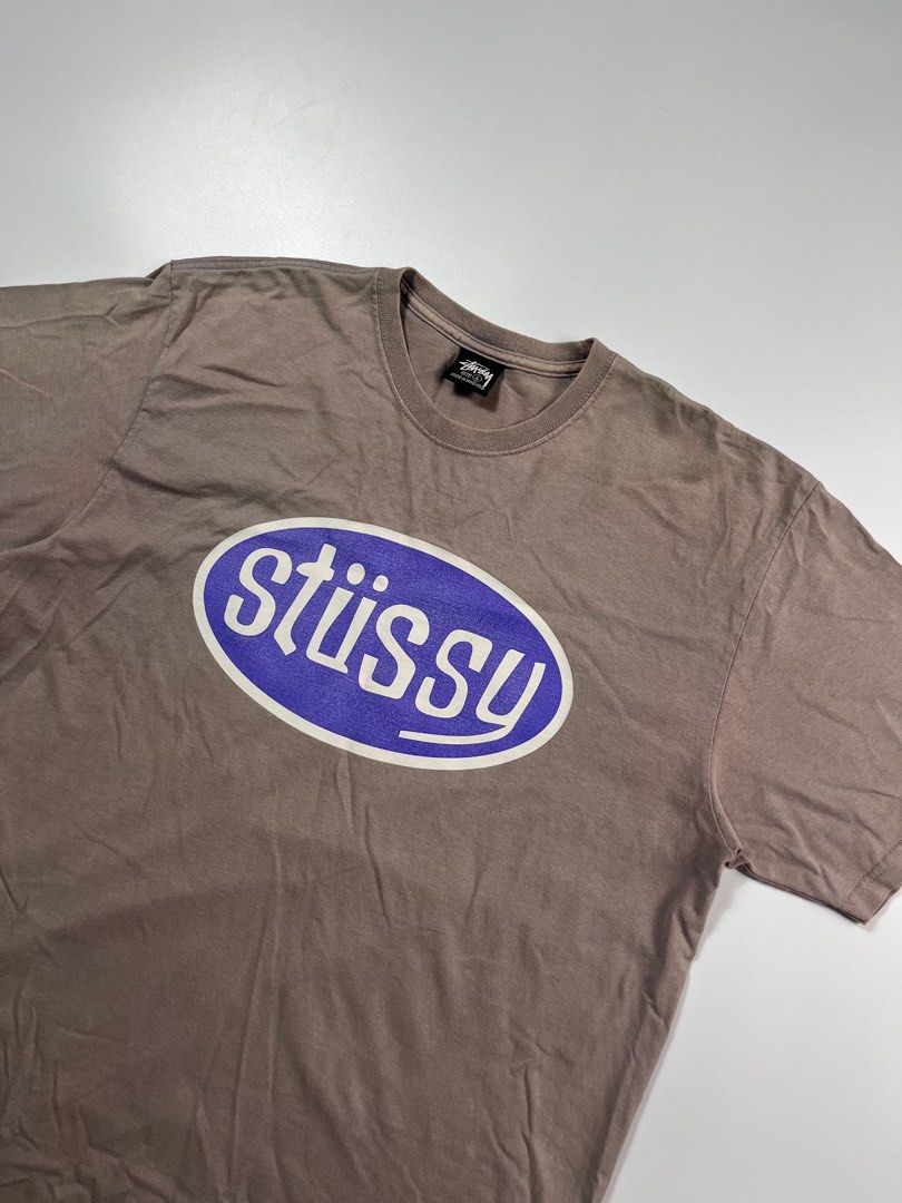 Stussy Oval Logo Tee Brown (Category: Tshirts & Polo Shirts ) located in Iloilo. Submitted by lowesdrift (Listing ID 1469208093, Image 3). Description: - Brand: Stussy - Color: Brown with a washed-out vintage tone - Size: L (Made in Honduras) - Design: Large oval logo printed on the back - Fit/Style: Crew neck with short sleeves - Material: Comfortable cotton fabric.