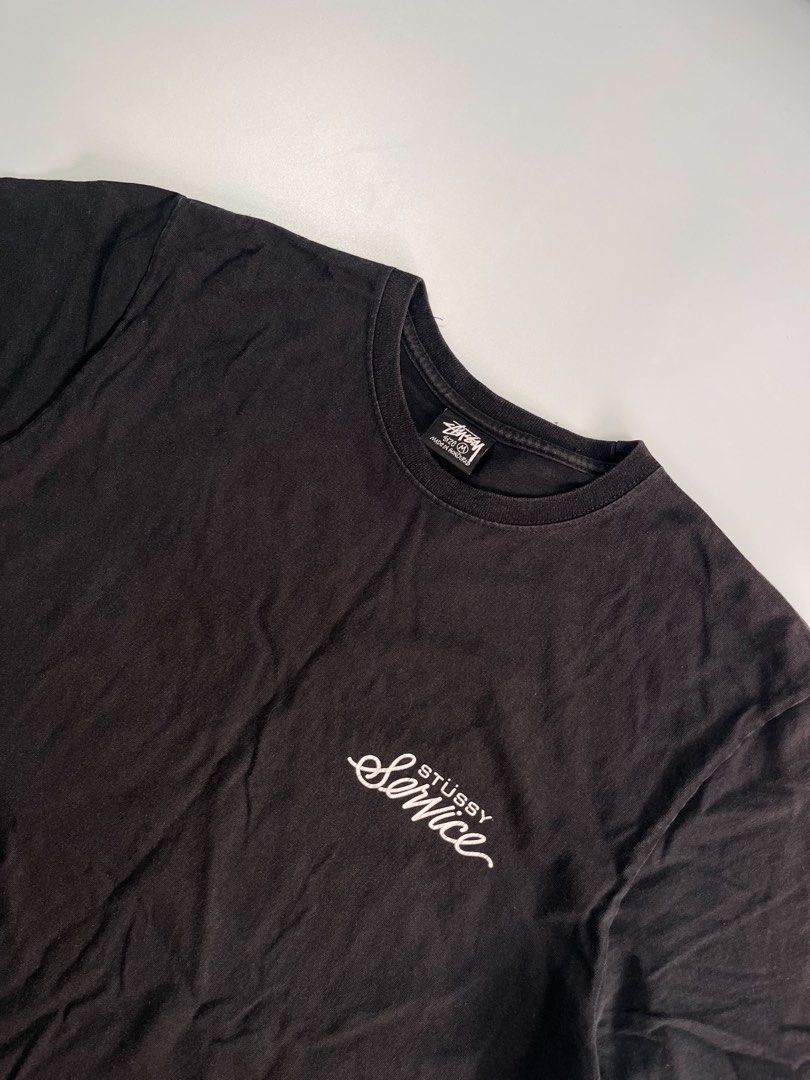 Stussy Service Black Graphic Tee Size M (Category: Tshirts & Polo Shirts ) located in Iloilo. Submitted by lowesdrift (Listing ID 1469204461, Image 3). Description: - Brand: Stussy - Item: Service T-Shirt - Color: Washed Black with natural vintage fade - Size: Medium (Tag size) - Material: 100% Cotton, Made in Honduras - Design: Small front left chest logo, large 'Stussy Service 949-989-4749' back graphic - Style: Classic crew neck, short sleeve 