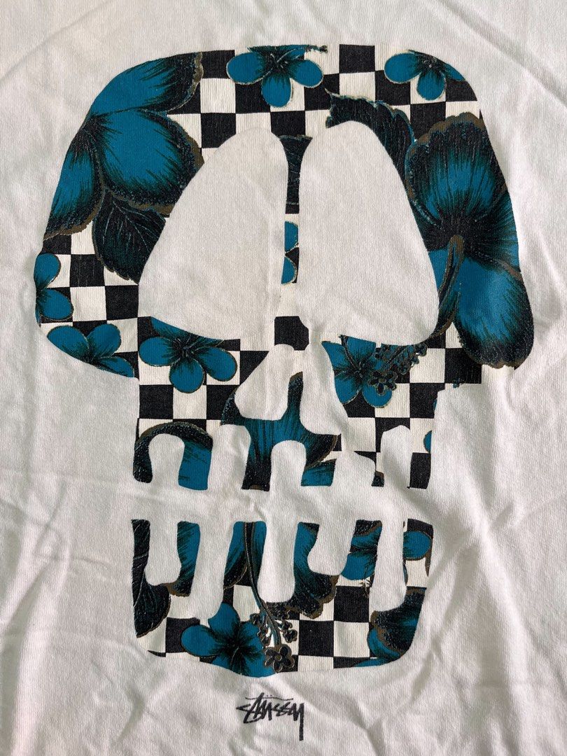 Stussy Skull Graphic Tee White Large (Category: Tshirts & Polo Shirts ) located in Iloilo. Submitted by lowesdrift (Listing ID 1469207141, Image 3). Description: - Brand: Stussy - Size: Large - Design: Large checkerboard skull print with blue floral details and signature branding - Neckline: Classic crew neck with original black brand tag - Condition: Soft and comfortably broken-in from normal wear - Style: Streetwear / Casual.