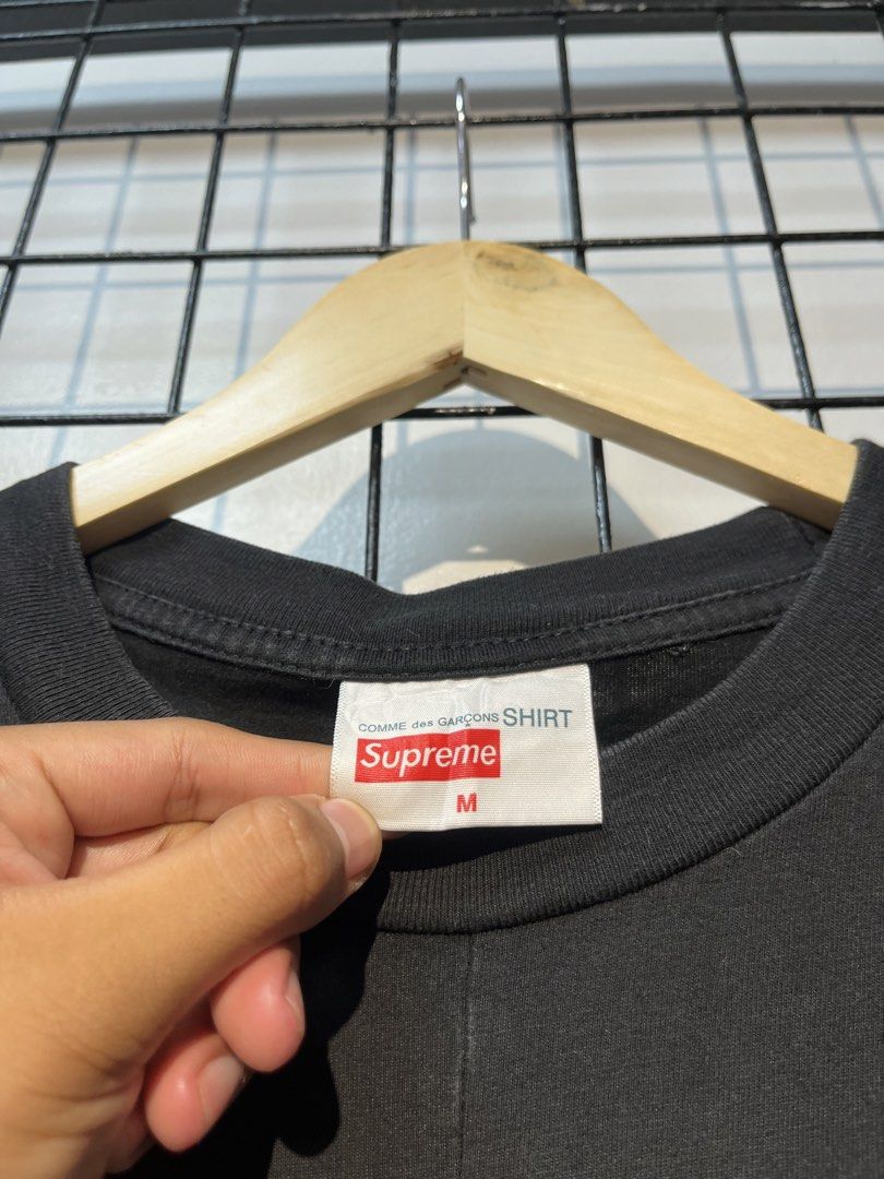 Supreme x Comme des Garçons SHIRT Split Box Logo Tee (Category: Tshirts & Polo Shirts ) located in Taal. Submitted by thrift_deals23 (Listing ID 1469184312, Image 2). Description: - Brand: Supreme x Comme des Garçons SHIRT - Item: Split Box Logo Tee - Color: Black - Size: Medium - Material: Cotton with woven interior labels - Design: Iconic upside-down text graphics and split box logo - Condition: Clean, graphics intact, highly sought-after stree