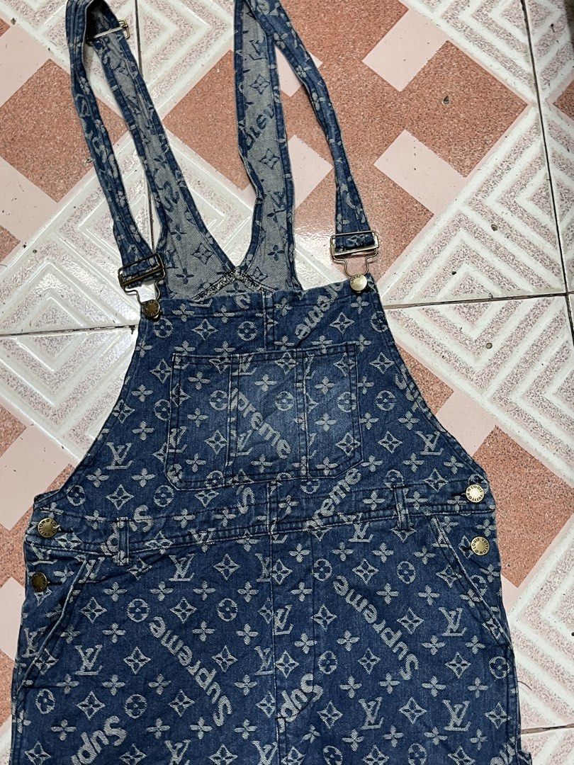 Supreme x Louis Vuitton Monogram Denim Overalls (Category: Luxury Apparel) located in Tabuk. Submitted by collectors_thrift_shop (Listing ID 1469167842, Image 2). Description: - Designer collab: Supreme x Louis Vuitton monogram print on heavy blue denim - Adjustable shoulder straps with durable metal buckles - Functional design with multiple utility pockets on front and back - patch on the back waist - Comfortable straight-leg fit for everyday we