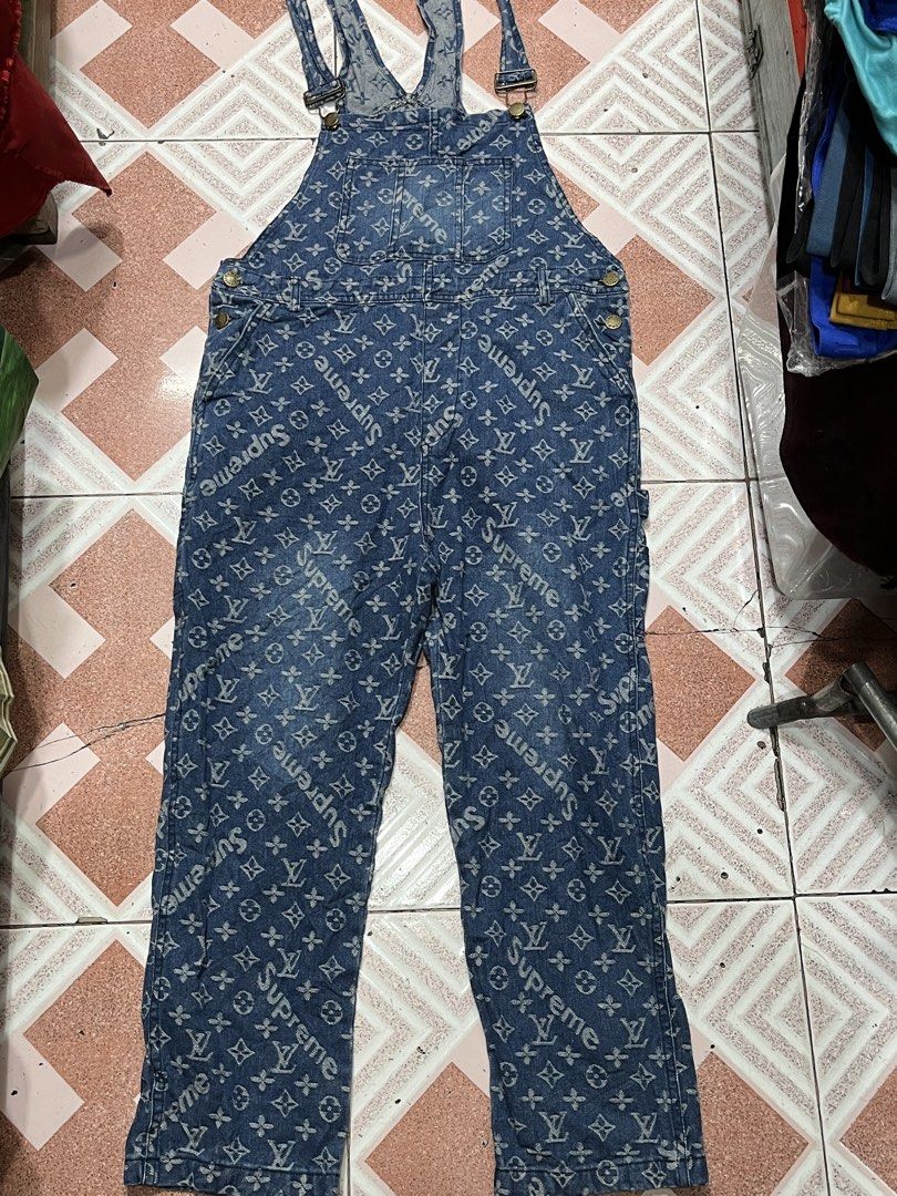 Supreme x Louis Vuitton Monogram Denim Overalls (Category: Luxury Apparel) located in Tabuk. Submitted by collectors_thrift_shop (Listing ID 1469167842, Image 1). Description: - Designer collab: Supreme x Louis Vuitton monogram print on heavy blue denim - Adjustable shoulder straps with durable metal buckles - Functional design with multiple utility pockets on front and back - patch on the back waist - Comfortable straight-leg fit for everyday we