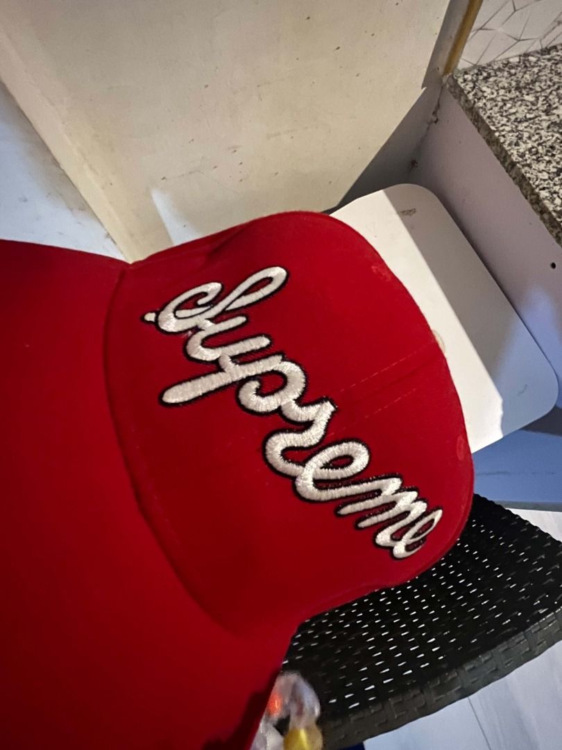 Supreme x New Era 59Fifty Script Fitted Cap Size 7 1/2 Red (Category: Caps & Hats) located in Caloocan City. Submitted by neiledrian (Listing ID 1469318907, Image 2). Description: - Brand: Supreme x New Era - Model: 59Fifty Script Fitted Cap - Color: Red with white cursive Supreme embroidery - Size: 7 1/2 - Details: Features a #1 patch on the side and a classic structured fit with a flat brim.