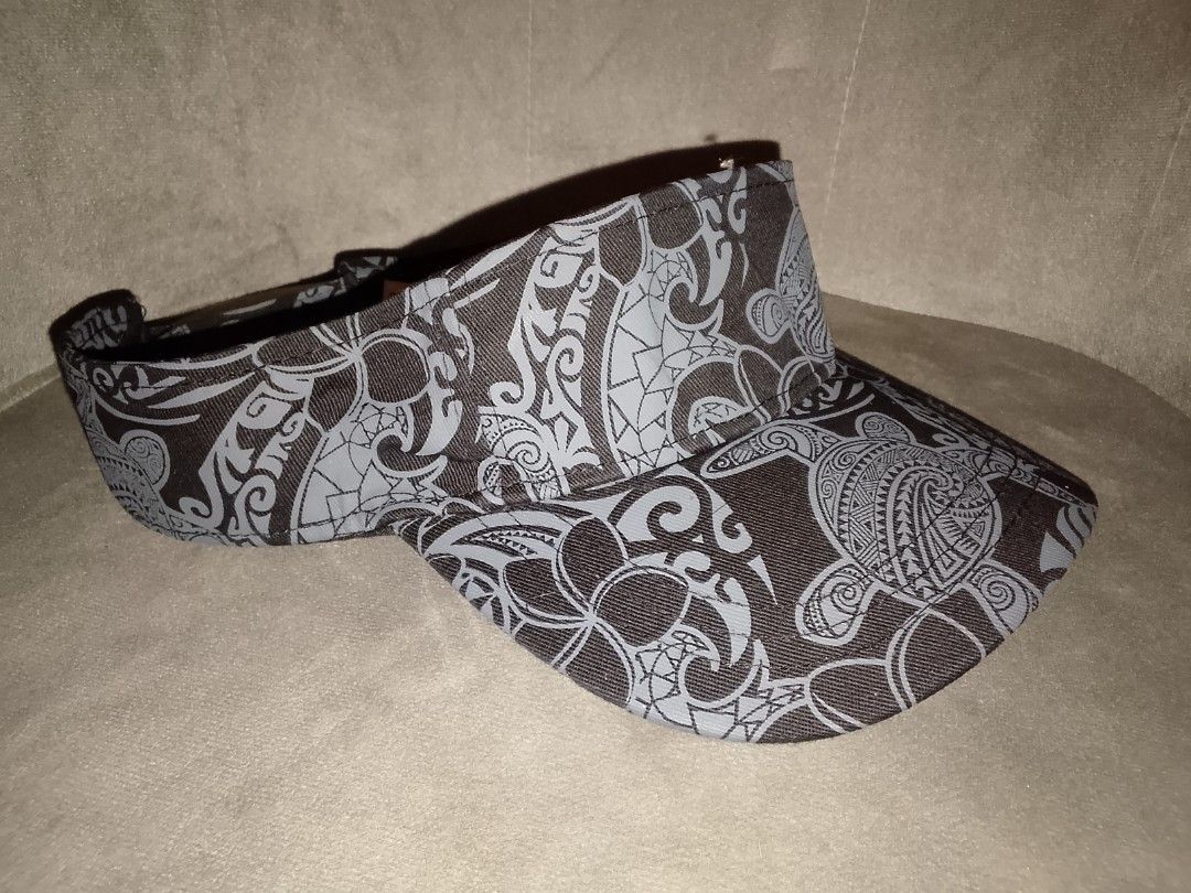 Surfware Hawaiian Classics Tribal Sea Turtle Print Sunvisor (Category: Hats & Beanies) located in Binangonan. Submitted by yuristalin888 (Listing ID 1469365582, Image 3). Description: * **Design & Style:** Features a bold, Polynesian-inspired tribal print complete with intricate sea turtle (*honu*) motifs and floral scrollwork in a stylish grey and black colorway. * **Fit & Comfort:** Designed with an easy **One Size Fits All** fit and an open-to
