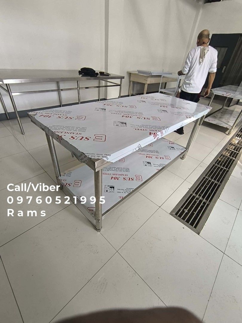 SUS 304 Stainless Steel Kitchen Work Table with Shelves (Category: Tables & Sets) located in Manila. Submitted by acykt18 (Listing ID 1469168825, Image 2). Description: - Material: Premium SUS 304 stainless steel - Storage: Multiple undershelves for extra space - Build: Heavy-duty construction with sturdy metal legs - Condition: Brand new with protective plastic film still intact - Ideal For: Restaurant kitchens, food prep, and home use - Assembl