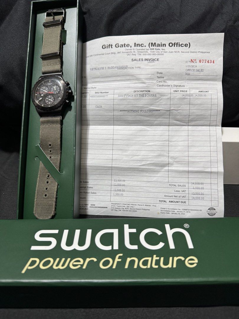 Swatch Irony Chrono By The Bonfire (Category: Men's Watches) located in Cavite. Submitted by mrswitchfoot (Listing ID 1469392729, Image 1). Description: - Model: Swatch Irony Chrono By The Bonfire (YVB416) - Dial: Black with textured 3D details and striking red and white print - Case: Brushed stainless steel with a sleek black PVD coating - Strap: Durable green textile strap with metal loops - Inclusions: Complete with original green box and offi