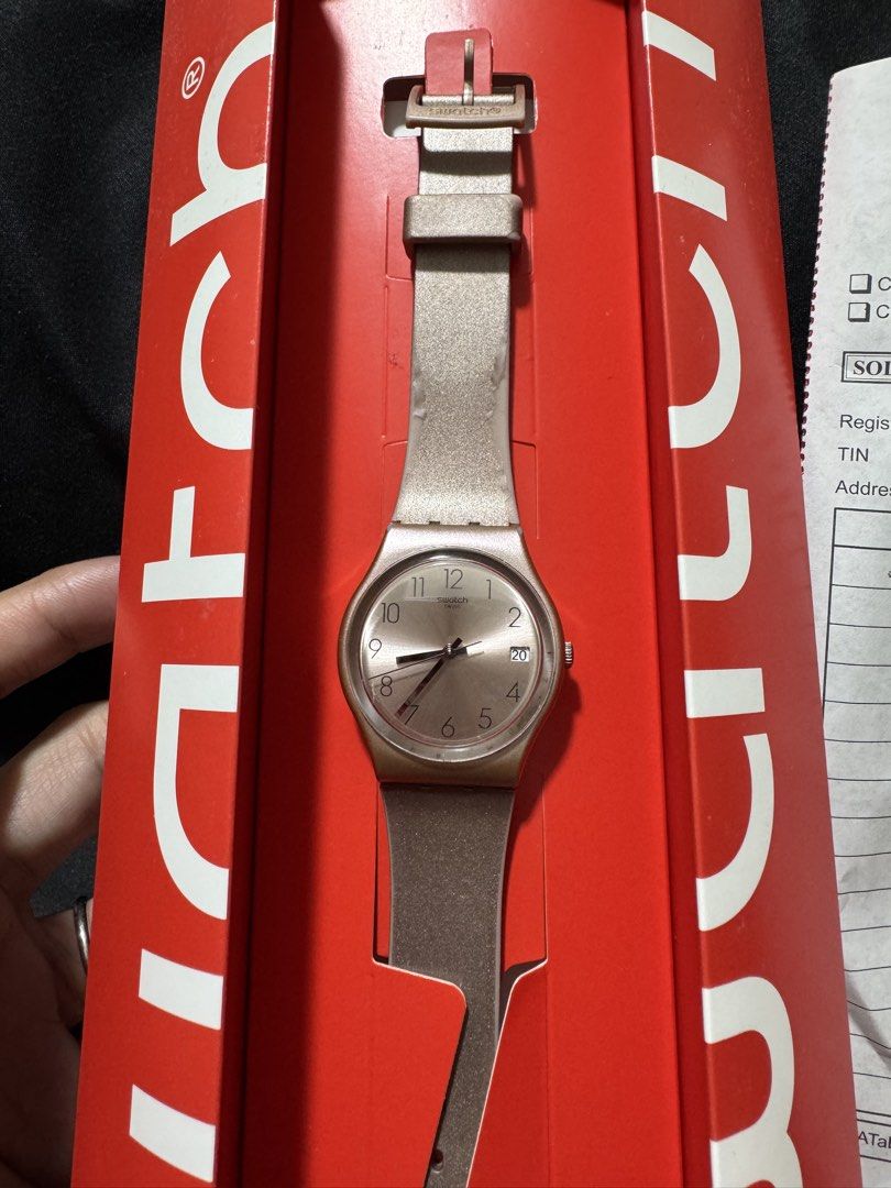 Swatch Pinkbata Basic Watch with Box and Receipt (Category: Women's Watches) located in Cavite. Submitted by mrswitchfoot (Listing ID 1469392892, Image 2). Description: - Brand: Swatch - Model: Pinkbaya Basic - Features: Metallic finish, classic analog dial, date window at 3 o'clock - Strap: Polymer strap with buckle closure - Inclusions: Original red packaging box and official SM Mall of Asia store receipt dated June 15, 2>**Complete paperwork i