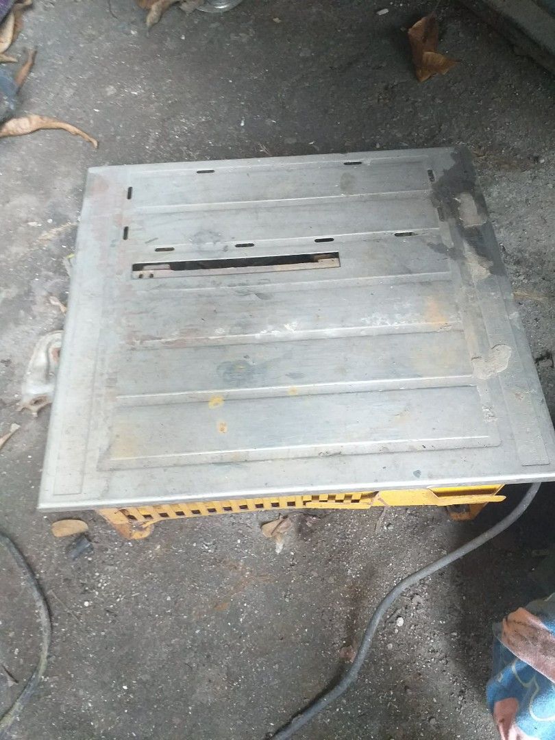 Table Top Tile Saw Wet Cutting Machine (Category: Construction Tools & Equipment) located in Quezon City. Submitted by madelrivera (Listing ID 1469272971, Image 3). Description: - Heavy-duty tile saw built for cutting ceramic and stone tiles - Sturdy yellow base with a durable metal tabletop - Integrated ruler scale along the left edge for precise measuring - Standard center blade slot and attached power cord - Shows minor dirt and rust spots fro