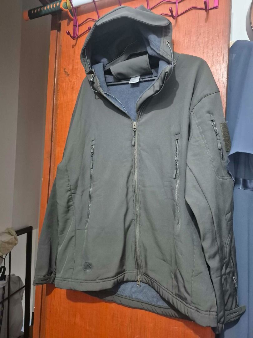 Tactical Softshell Hooded Jacket Olive Green (Category: Coats, Jackets and Outerwear) located in Pasig City. Submitted by kathee88 (Listing ID 1469190094, Image 2). Description: - Color: Olive green - Lining: Cozy fleece interior for extra warmth - Closure: Full zip front - Pockets: Vertical zippered chest pockets and extra sleeve pocket with velcro patch area - Hood: Attached with adjustable drawstrings - Fit: Standard fit with sturdy, durable m