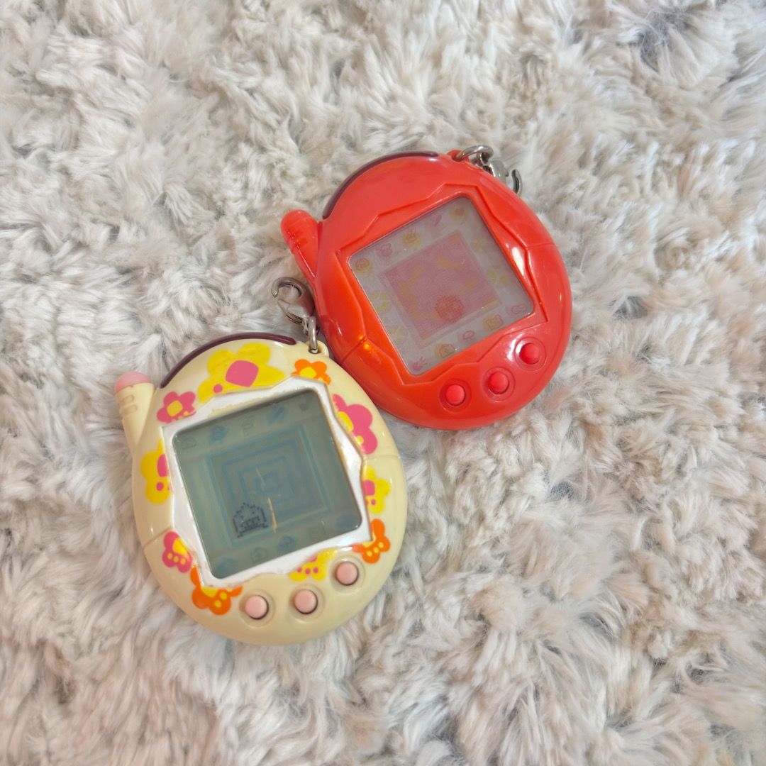 Tamagotchi Akai and Keitai Bundle (Category: Interactive Toys) located in Marikina City. Submitted by majo-esguerra (Listing ID 1469179062, Image 1). Description: For set only 700php. No battery corrosion. Akai - Red Pixels - Only issue is the b button of akai is a bit hard to press. Keitai - all are working. It has a scratch on the screen..