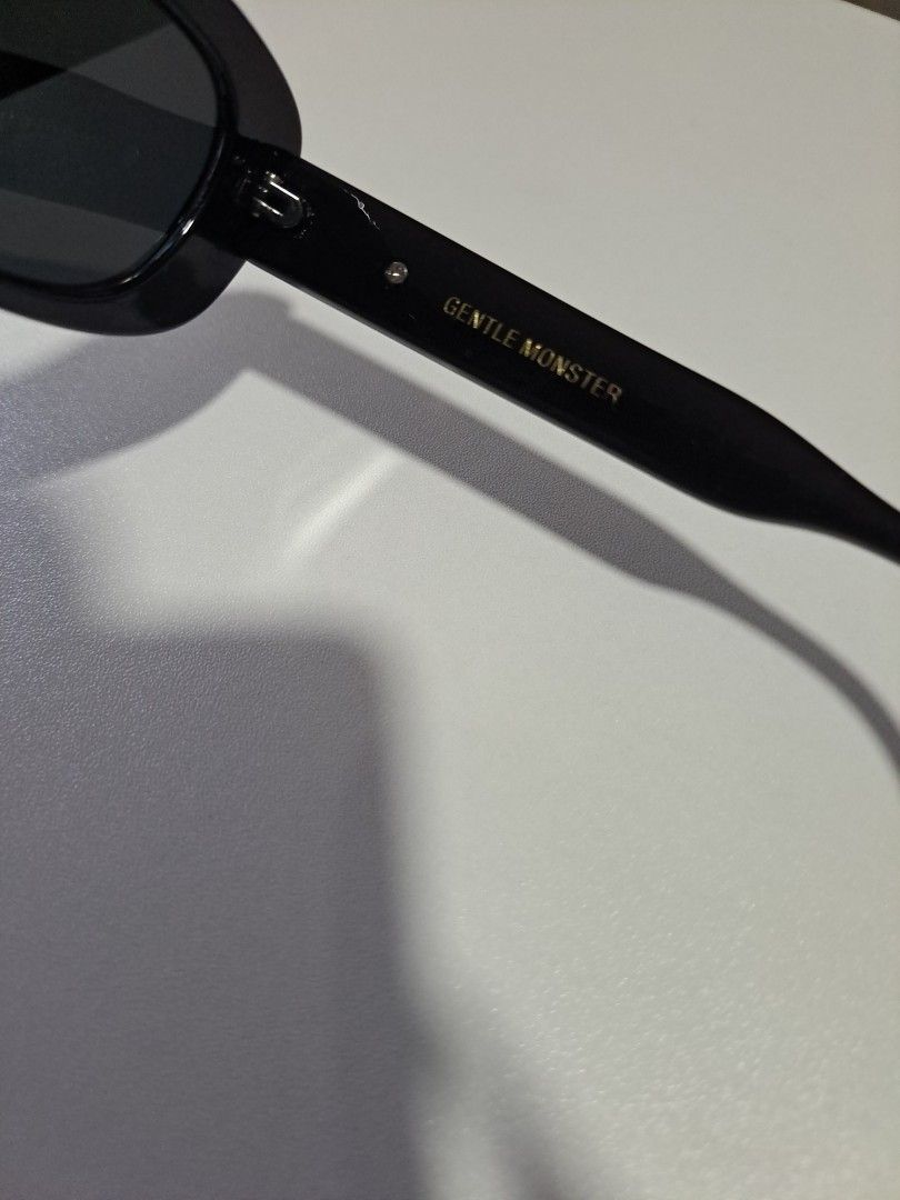 Tambu Sunglasses Black (Category: Sunglasses & Eyewear) located in Pasig City. Submitted by aecollection03 (Listing ID 1469171832, Image 3). Description: - Brand/Model: Gentle Monster Tambu - Color: Classic black - Lenses: Dark tinted - Details: Gold inner temple lettering and metal side hinges - Style: Chic and versatile everyday eyewear - will provide hardcase for shipping.