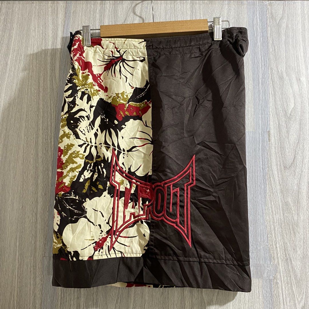 Tapout Floral Board Shorts (Category: Shorts) located in Manila. Submitted by _thriftanddrip (Listing ID 1469339808, Image 2). Description: Large 34 x 20 ₱750 free shipping Tapout board shorts with a split brown and floral pattern design. Large embroidered logos on the front and back. Red inside waist tag with brand lettering. Drawstring closure at the waist. Lightweight fabric, great for summer or casual wear. Clean condition overall..