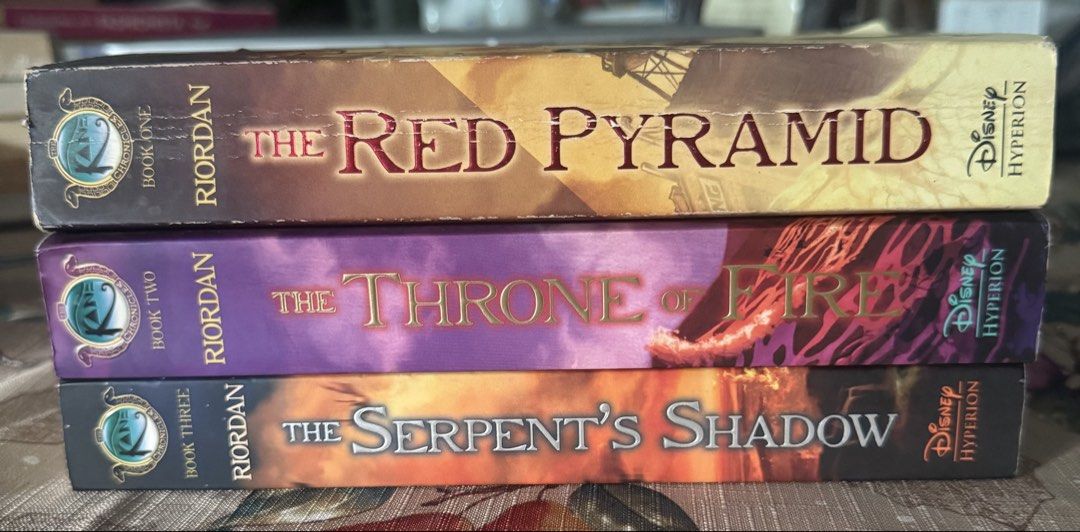 The Kane Chronicles Complete Trilogy by Rick Riordan (Category: Storybooks) located in Paranaque City. Submitted by jiggybautista (Listing ID 1469388034, Image 1). Description: - Title: The Kane Chronicles 3-Book Bundle by Rick Riordan - Books included: The Red Pyramid, The Throne of Fire, and The Serpent's Shadow - Format: Paperback - Condition: Read once, clean pages, with minor shelf wear on edges - Perfect for: Fantasy and adventure book love