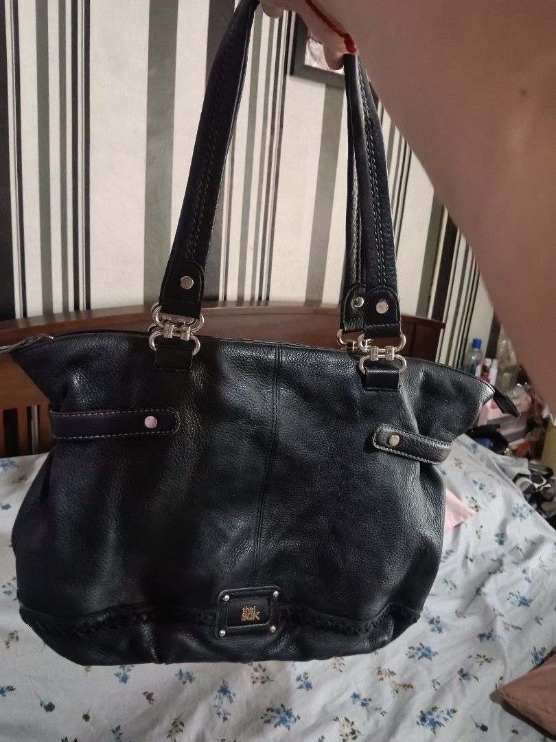 The Sak Torrence Tote Black Leather Bag (Category: Tote Bags) located in Quezon City. Submitted by bshoppe_ (Listing ID 1469160736, Image 1). Description: - Brand: The Sak (Torrence Model) - Material: Genuine textured pebble leather - Color: Classic Black - Design: Structured everyday tote with sturdy shoulder straps - Details: Chic metal hardware and stylish braided trim near the bottom - Condition: Excellent, roomy and functional for daily esse