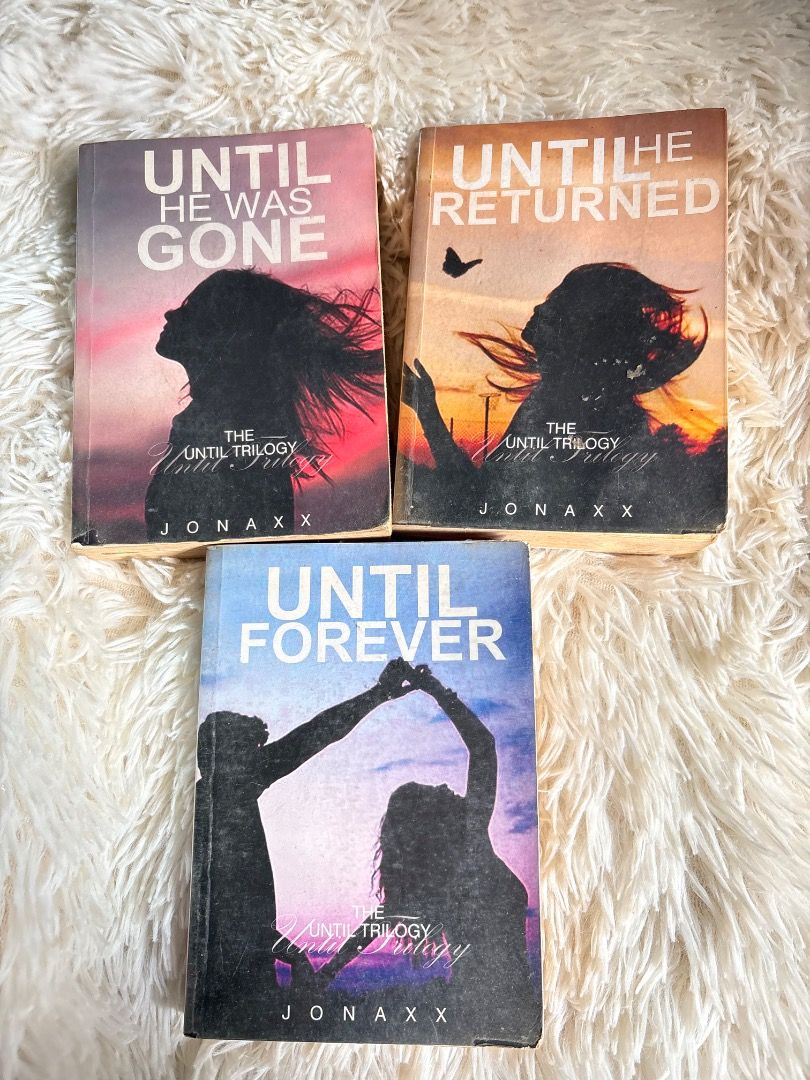 The Until Trilogy by Jonaxx Books Set (Category: Storybooks) located in Manila. Submitted by ladyoflight (Listing ID 1469269127, Image 2). Description: - Title: The Until Trilogy by Jonaxx (Set of 3 books: Until He Was Gone, Until He Returned, Until Forever) - Condition: Pre-loved with noticeable yellowing and foxing spots - Cover: Edge wear present, reinforced with plastic tape on the inner covers - Perfect for Jonaxx Stories (JSLs) looking for 
