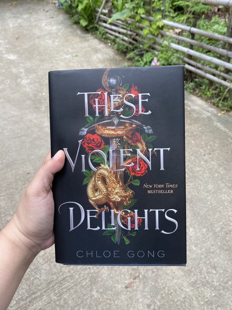These Violent Delights & Our Violent Ends by Chloe Gong (Category: Storybooks) located in Poro. Submitted by rikkisprelovedthings (Listing ID 1469334705, Image 2). Description: - Set of 2 bestselling YA fantasy novels by Chloe Gong - Includes: These Violent Delights and Our Violent Ends - Format: Hardcover editions with original dust jackets - Condition: Clean pages, sharp corners, minimal shelf wear - Perfect for fans of dark historical romance 