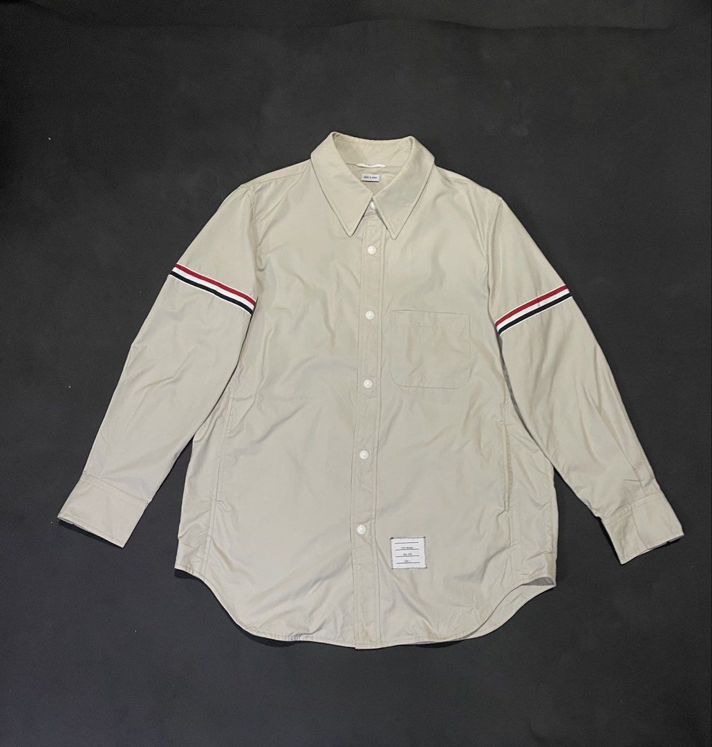 Thom Browne Nylon Shell Shirt Jacket with Armbands (Category: Luxury Apparel) located in Bocaue. Submitted by mosthighcollective (Listing ID 1469162647, Image 1). Description: Thom Browne Nylon Shell Shirt Jacket with Armbands Size: 2 on tag ( L to XL) Dimes: 23 width 29 length Good as new No issue 6,500 only Dm me to purchase 📥.