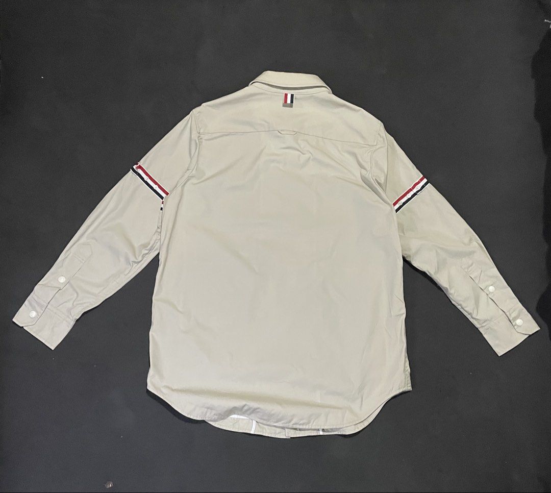Thom Browne Nylon Shell Shirt Jacket with Armbands (Category: Luxury Apparel) located in Bocaue. Submitted by mosthighcollective (Listing ID 1469162647, Image 2). Description: Thom Browne Nylon Shell Shirt Jacket with Armbands Size: 2 on tag ( L to XL) Dimes: 23 width 29 length Good as new No issue 6,500 only Dm me to purchase 📥.